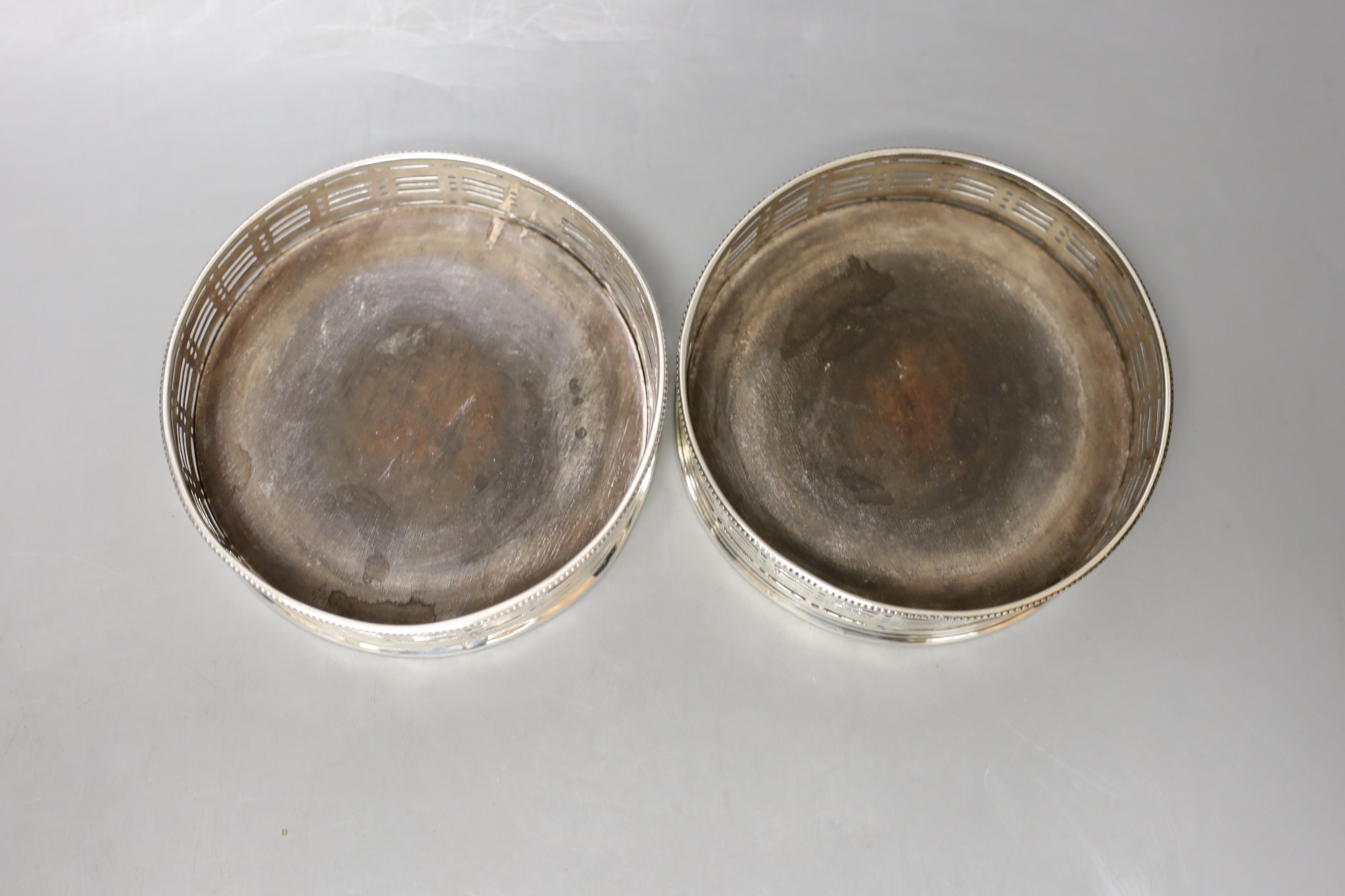 A pair of 19th century pierced silver wine coasters, marks rubbed, diameter 12.1cm (a.f.).